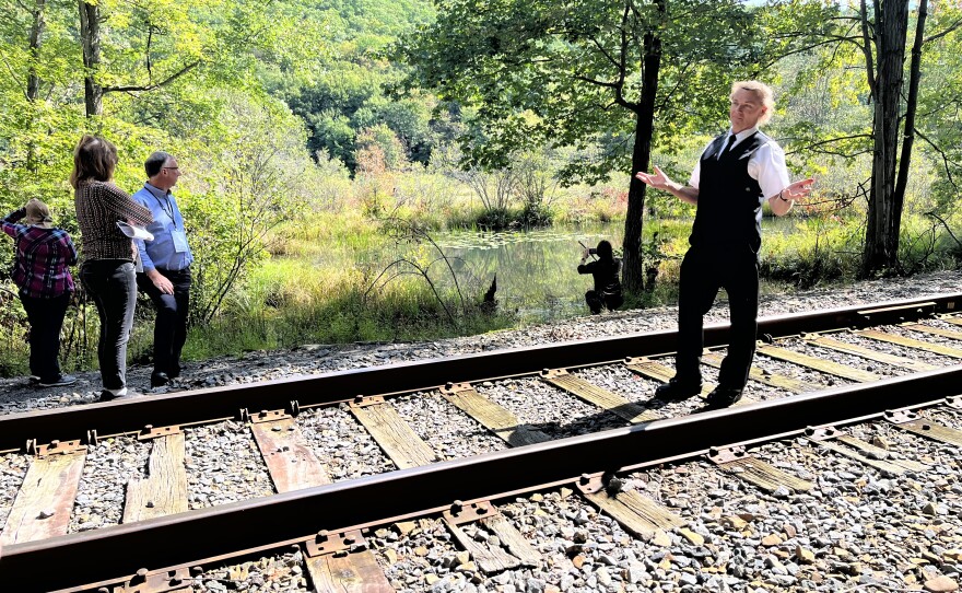 Jim Kosydar, conductor of the Electric City Trolley, chats with a group from the PA Greenways and Trails Summit at a new piece of preserved land in Scranton.