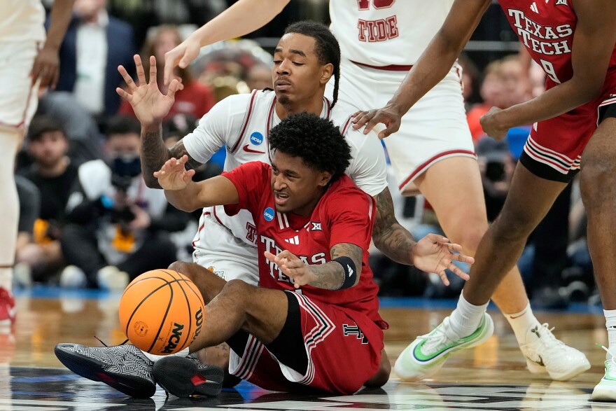 Texas Tech guard Jaylen Petty (11) battles with Alabama guard Labaron Philon (0) for a loose ball during the first half in the second round of the NCAA college basketball tournament Sunday, March 22, 2026, in Tampa, Fla. (AP Photo/Chris O'Meara)
