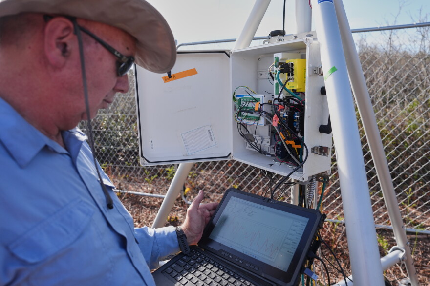 Neal Flanagan, a research scientist at Duke University, displays real-time carbon dioxide emissions from a sensor Wednesday, May 6, 2026, in Belhaven, N.C.