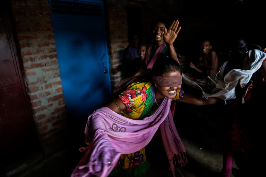 Nirma, 16, plays with her friends. She is married but still lives with her parents and talks to her husband on the phone sometimes. She is nervous about the duties she'll have to take on when she does move in with her husband. At the moment, she hopes to graduate high school and eventually become a doctor.