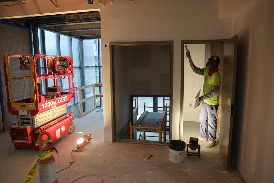 Dexter Rhoden, with Upstate Interiors, finishes drywall near the new front entrance of the Maplewood Community Library, which includes a handicap-accessible lift. The expansion and renovation project is nearing completion and is scheduled to reopen in March 2026. The renovations include a secure outdoor play space, a new parking lot, separate spaces for classes and tutoring, a new community meeting room and updated restrooms.