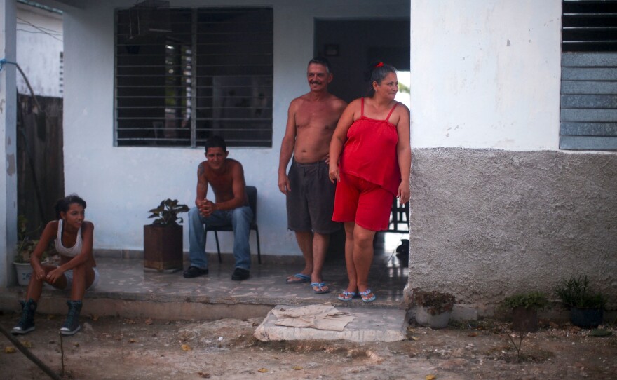 The company that employs Juanito Cruz (second from right) gave his family their home. It's located near the sugar factory in Madruga, Cuba, where Cruz has worked for 31 years.