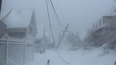 Downed power lines on a snow covered road in provincetown.