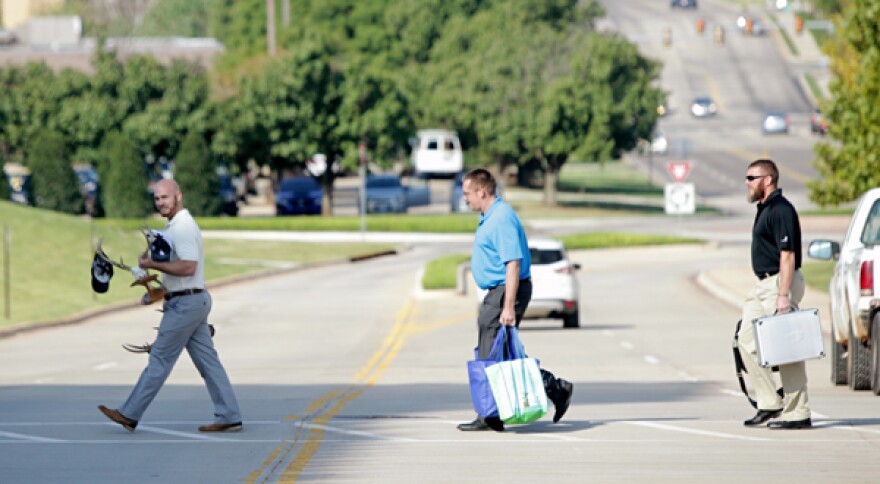 Chesapeake Energy employees leave buildings after layoffs were reported Sept. 29, 2015.