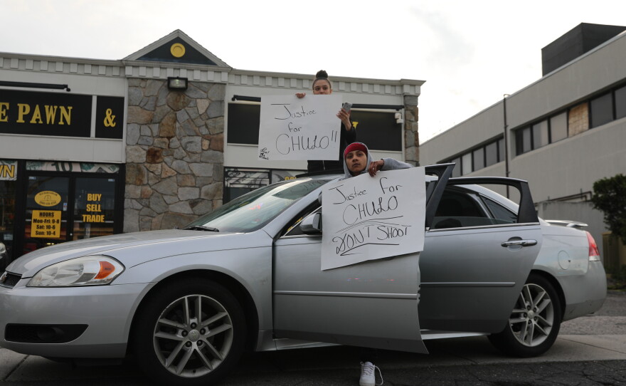 Demonstrators protest across the street from the Wethersfield Police Department on Thursday evening
