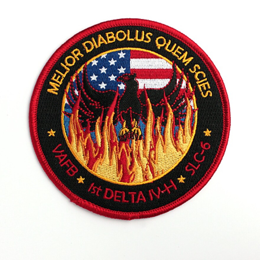 The mission patch for the USA 224/NROL-49 satellite includes the Latin phrase "better the devil you know."