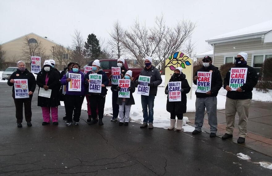 Members of SEIU 1199 gather on the Weinberg Campus, holding one of several quiet pickets Thursday to call on statewide nursing home reforms. CREDIT MICHAEL MROZIAK, WBFO