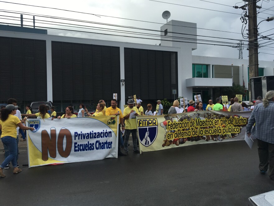 Teachers protest outside Puerto Rico's Department of Education. An education reform bill in the legislature would allow charter schools in the island's public school system, something the teachers' unions oppose.