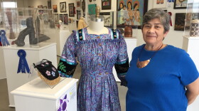 Tonia Weavel stands beside her award-winning tear dress for the 51st Trail of Tears Art Show