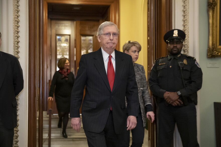 Senate Majority Leader Mitch McConnell, R-Ky., steps out of the chamber prior to a vote Thursday on ending the partial government shutdown.