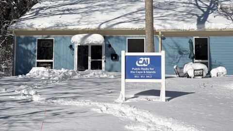 a snowy building with a sign that says "CAI Public Radio for the Cape and Islands"