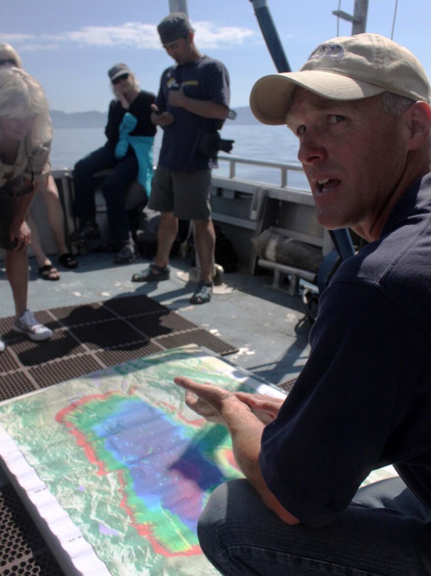 Researcher Brant Allen of UC-Davis explains features of Lake Tahoe to a group of passengers on board a research vessel.