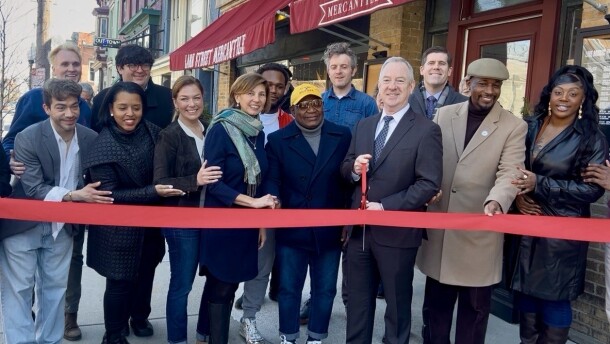 Lark Street Business Improvement District leaders are joined by local lawmakers and business owners to cut a ribbon during a celebration of new businesses on the strip on Wednesday, April 8, 2026.