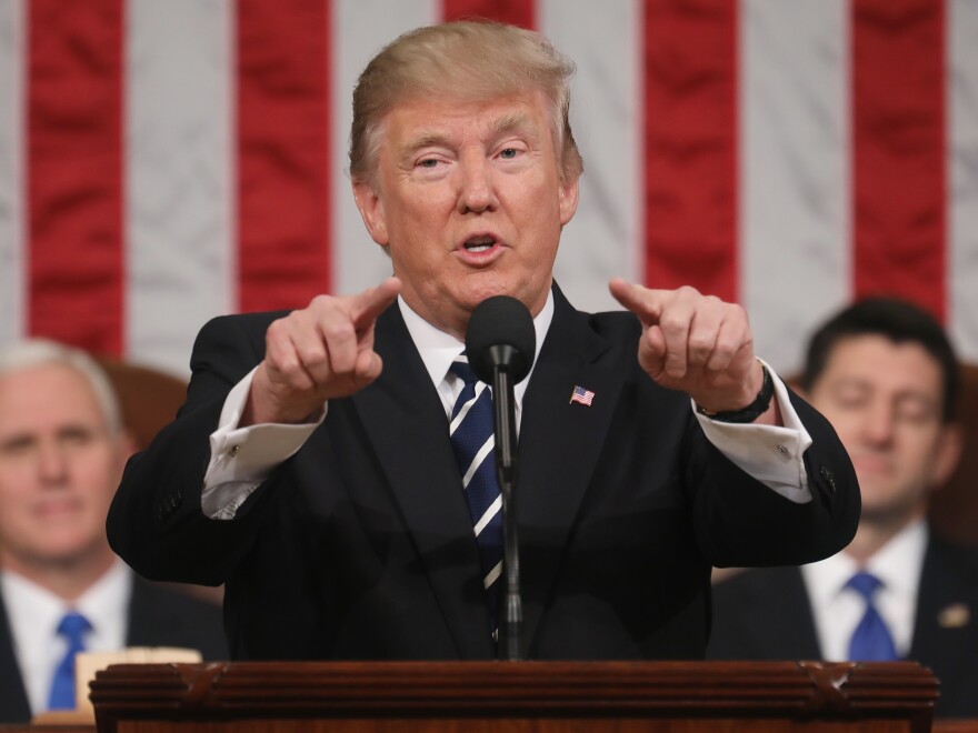 President Donald J. Trump delivers his first address to a joint session of the U.S. Congress as U.S. Vice President Mike Pence (L) and Speaker of the House Paul Ryan (R) listen on February 28, 2017 in the House chamber of the U.S. Capitol in Washington, D.C.