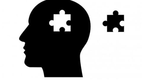 Picture of a head silhouette with a missing puzzle piece, representing mental health awareness.