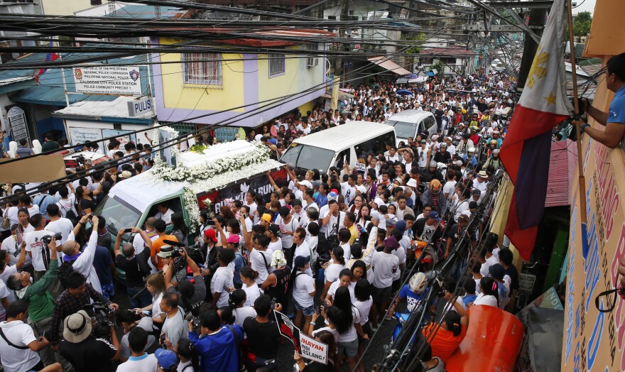 Protesters and supporters pause during a rally outside the police precinct where officers involved in the killing of Kian Loyd delos Santos were assigned during his funeral on Aug. 26, 2017, in suburban Caloocan city north of Manila, Philippines.