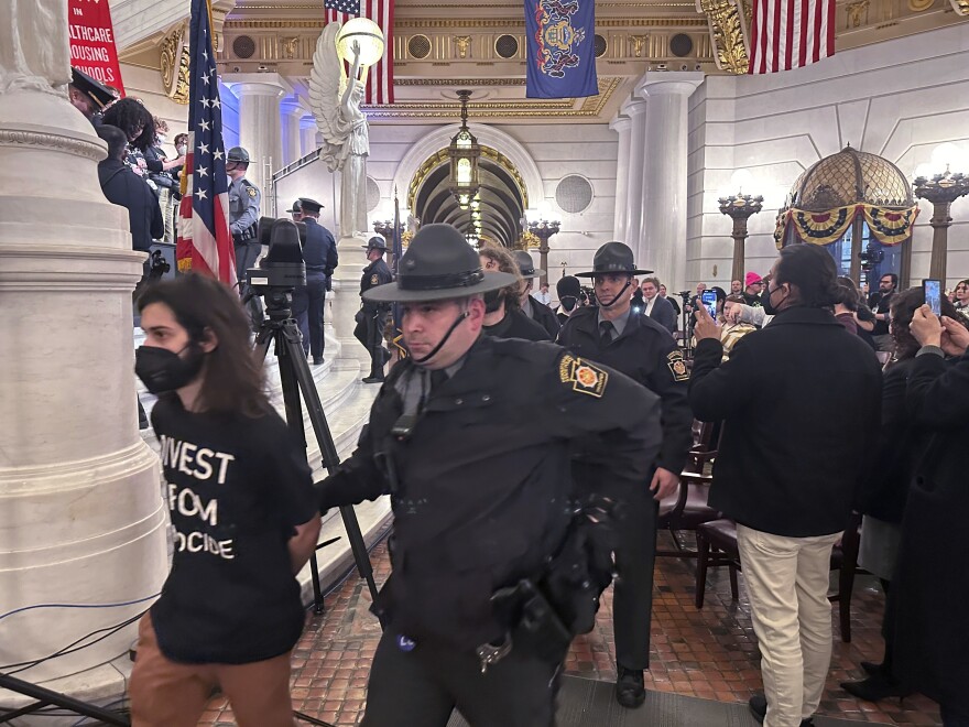 Police arrest some of about 200 people taken into custody on Monday, Feb. 5, 2024, in the Rotunda of the State Capitol in Harrisburg, Pennsylvania. The arrests shut down a demonstration against the state Treasury Department's investment of about $56 million in Israel bonds. The protest was organized by Jewish Voice for Peace, the Philly Palestine Coalition and the Pennsylvania Council on American-Islamic Relations.