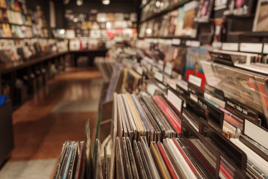 A  close-up view of neatly organized vinyl reocrds in a vintage-style music store.