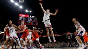 UConn guard Braylon Mullins (24) rebounds against Illinois during the second half of an NCAA college basketball game.