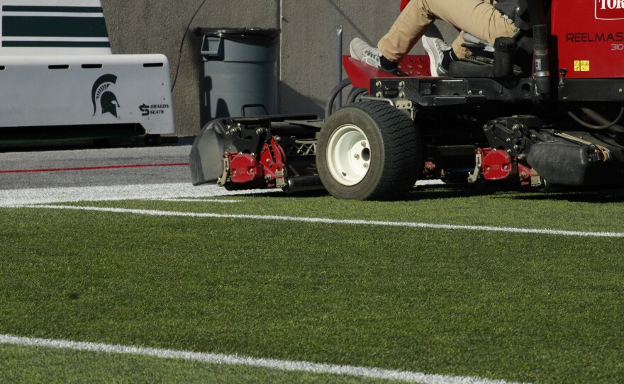 - The football sideline at Spartan Stadium Before Michigan State’s Football game against Penn State on Nov. 14, 2025. - McDougal Striping the field before Michigan State’s Football game against Penn State on Nov. 14, 2025. - NCAA Women's Soccer Tournament Banner at the Old College Field Gates on Nov. 14, 2025. - The soccer field at DeMartin Stadium on Nov. 14, 2025, the day before the first round of the NCAA Women’s Soccer Tournament. - Michigan State athletic turf workers performing final checks on the field at DeMartin Stadium ahead of the first round of the NCAA Women’s Soccer Tournament, Nov. 14, 2025 - Michigan State Athletic Turf workers inspecting the field ahead of the first round of the NCAA Women’s Soccer Tournament, Nov. 14, 2025 - Spartan Turf logo displayed under the bleachers at Spartan Stadium, Nov. 14, 2025