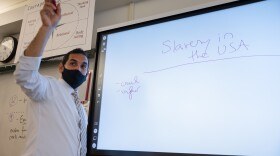 Adrian Solis teaches a Black and Latino history class at Abbott Technical High School in Danbury, Conn. The class’s curriculum is being piloted at 50 schools across the state after the state legislature passed a law requiring high schools to offer courses on African, Black, Puerto Rican, and Latino studies. He began the lesson by asking students to each share a single word that comes to mind when they see the phrase “Slavery in the USA.”