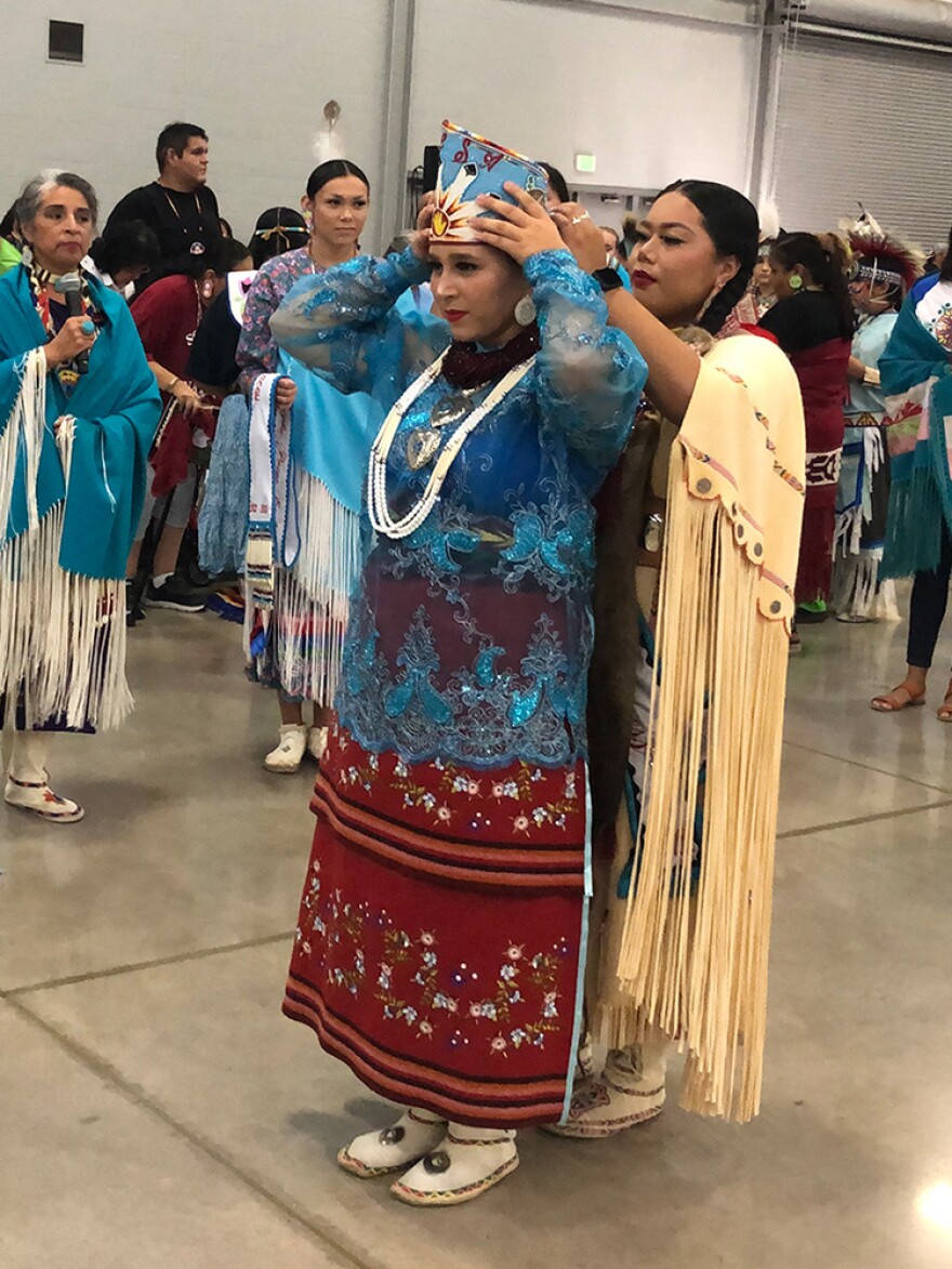 19-year-old Leigha Easley of Pawhuska is crowned 2022-23 Tulsa Powwow Princess by Jasmine Phetsacksith, who held the title from 2019 to 2022.