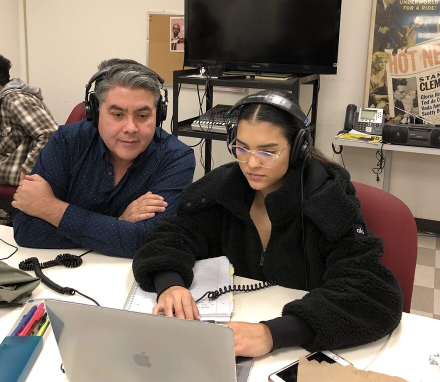 Two people looking at laptop.