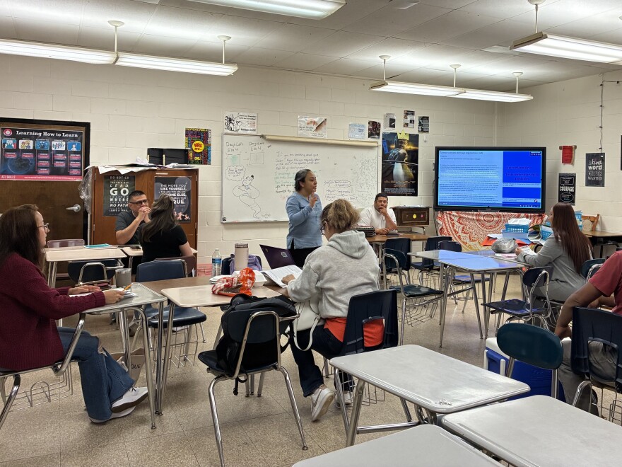 Adults in the Spanish GED preparation program listen to their teacher during a class at Parkland High School in Winston-Salem at the end of May.