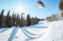 A skier jumps high up into the air going down a snowy run at the Eldora Mountain Ski Resort in Boulder County.