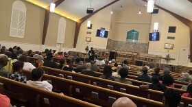 People gather in Greater Peace Missionary Baptist Church for a town hall meeting