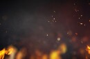 Flames and fire embers over a dark background