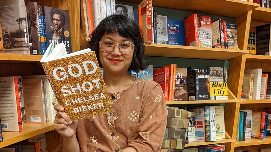 Michelle Malonzo with Chelsea Bieker's book "Godshot."