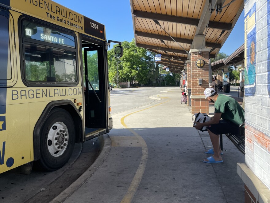 People wait for their bus at the Rosa Parks bus station. (Aileyahu Shanes/WUFT News)