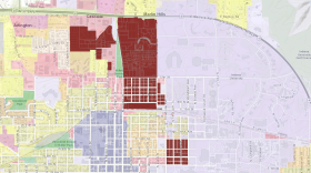 The areas in red indicate the three districts zoned for student housing as the blue area represents downtown Bloomington.
