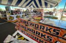 Shoppers grab some last-minute offerings from a pop-up fireworks stand in St. George, J