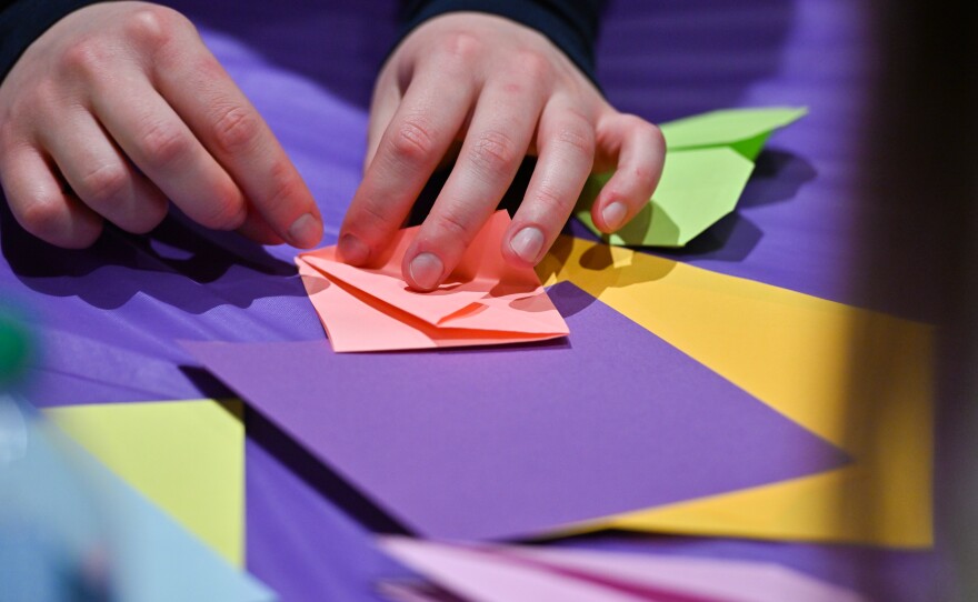 A student makes an origami horse for Lunar New Year.
