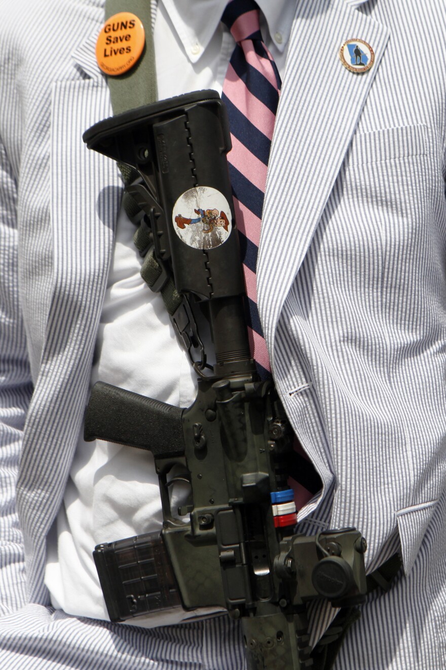 A gun advocate displays his rifle across his chest in protest at a gun control rally at the Georgia State Capitol last June. Gun rights activists in Georgia have been trying for years to pass versions of the Safe Carry Protection Act, which will go into effect in the state on July 1.