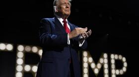 a man in a tie claps