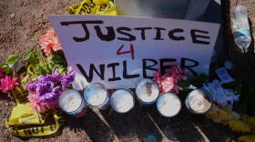 Flowers and candles are seen near the site where a Venezuelan man was shot in his vehicle by an ICE officer in Austin, Texas, Monday, Sept. 21, 2026. (Eric Gay/AP)