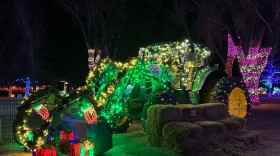 Green tractor wrapped in lights at Washington Park 