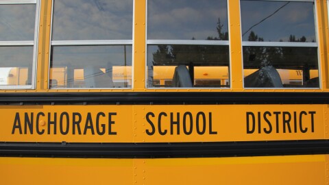 The side of a yellow school bus that says "Anchorage School District"