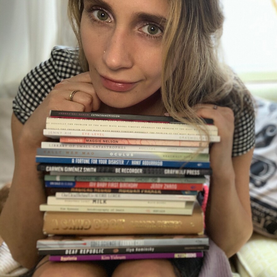 Sadie Dupuis and her many volumes of poetry.