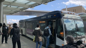 Passengers board an IndyGo bus.