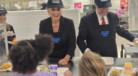Governor Gretchen Whitmer and state Senator Sean McCann pass out school lunches in Kalamazoo on September 8, 2026.