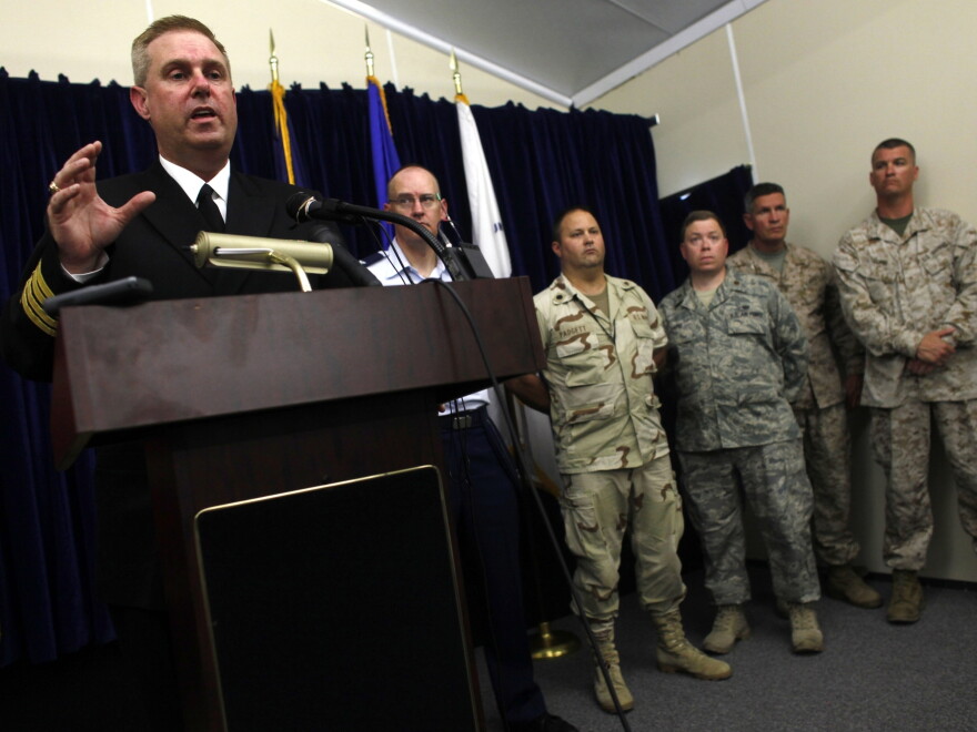 Navy reservist Capt. John Murphy (L), former chief prosecutor of military commissions at Guantanamo Bay, speaks during a press conference in 2009.