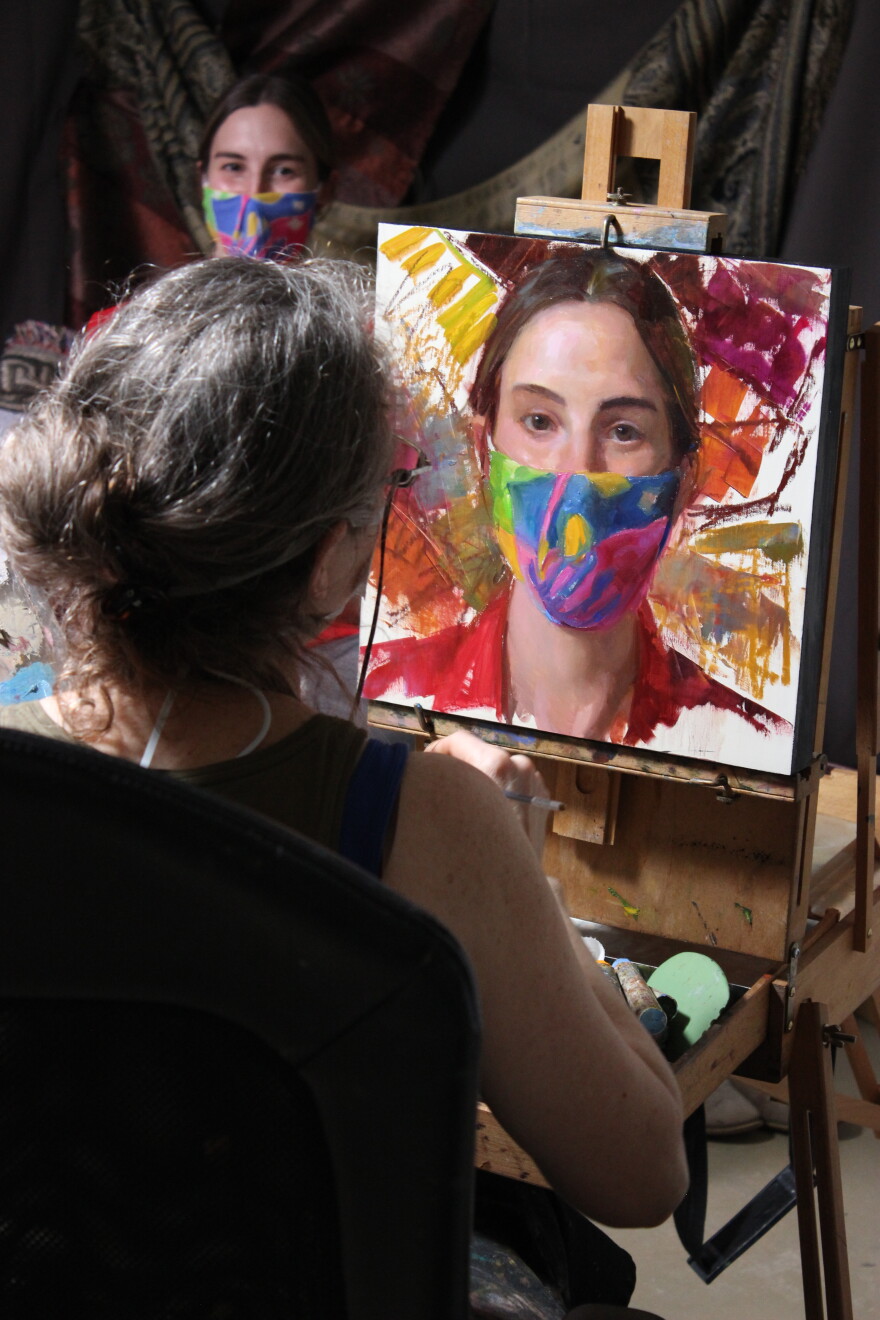 Rose Frantzen paints third-year Veterinary Medicine student Catharine Found as part of the Faces of Iowa State series.