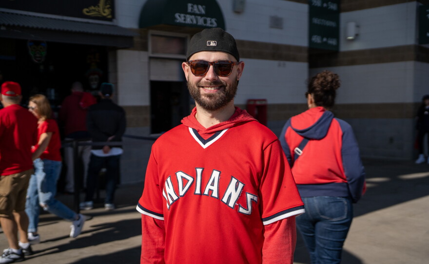 Man in Guardians jersey stands on concourse.