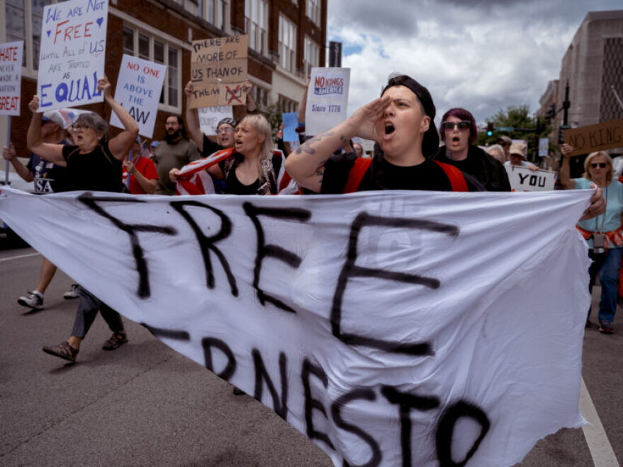 Megan Wingfield of Bowling Green chants and marches while holding a banner reading “Free Ernesto” during the “No Kings” protest in Bowling Green, Ky., on Saturday, June 14, 2025. The banner refers to the recent detainment of local teenager Ernesto Manuel-Andres by ICE, despite his legal status. He was later released.