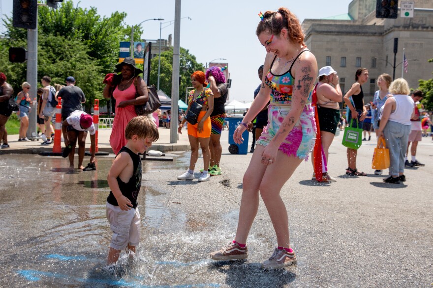 Ariana Gibson, right, and her son Kai, 3, play in the puddles caused by water streaming from a fire truck on Saturday, June 24, 2023 at St. Louis Pride Fest in downtown St. Louis. “I’m bisexual and I have been around LGBT-everything my entire life,” Gibson said. “It’s a fun place to be.”