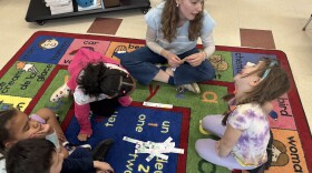 Kindergarten teacher Jacqueline Gleason-Boure talks with Josephine Ziniti during a math lesson at Weston Elementary School in Manchester. Students learn all their core subjects in French through the district's language immersion program. Other classes are learning in Spanish.